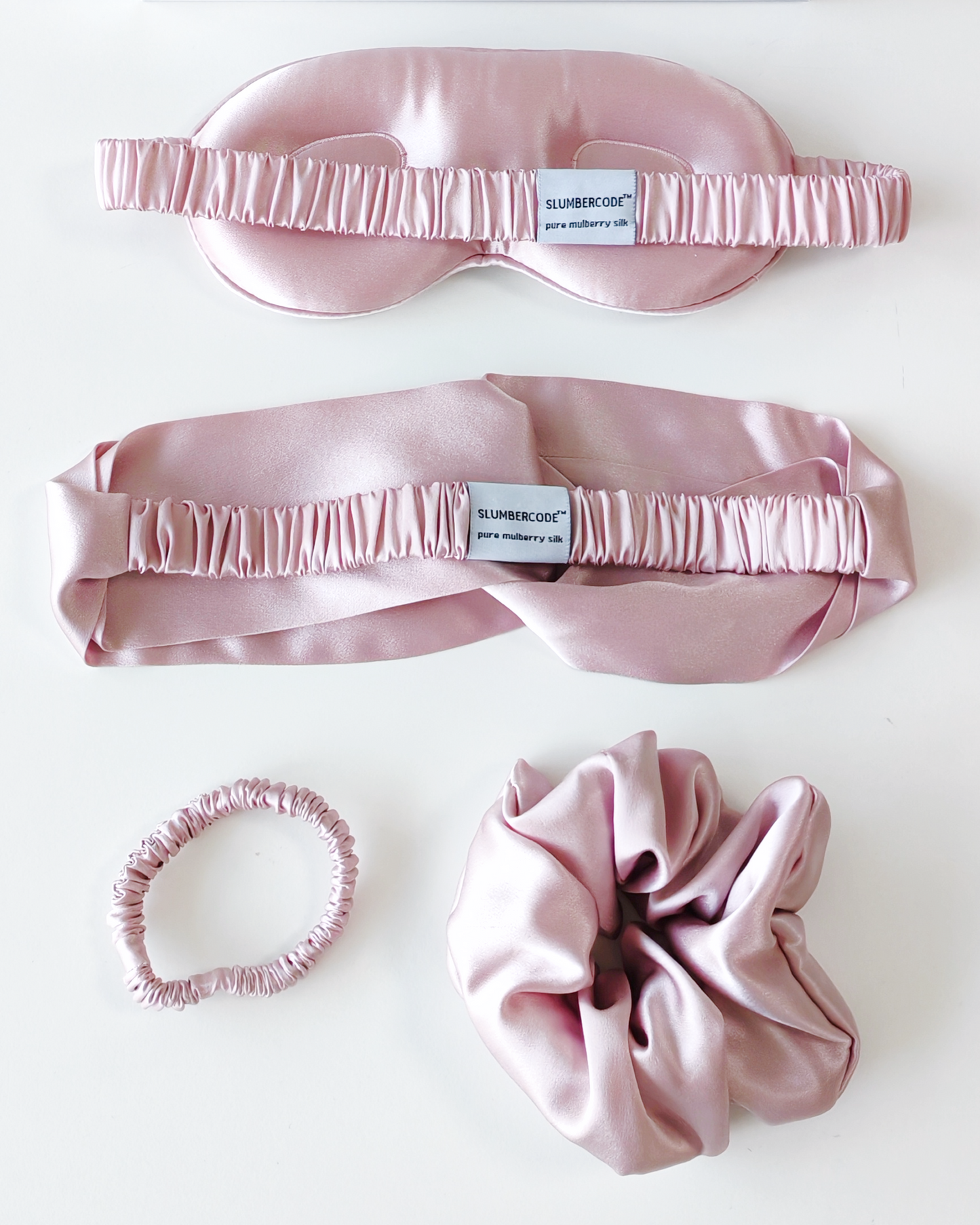 Dusky Pink Signature Slumber essential silk set., featuring a 22 momme pure mulberry silk sleep mask, headband, and scrunchies.