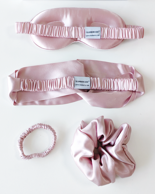 Dusky Pink Signature Slumber essential silk set., featuring a 22 momme pure mulberry silk sleep mask, headband, and scrunchies.