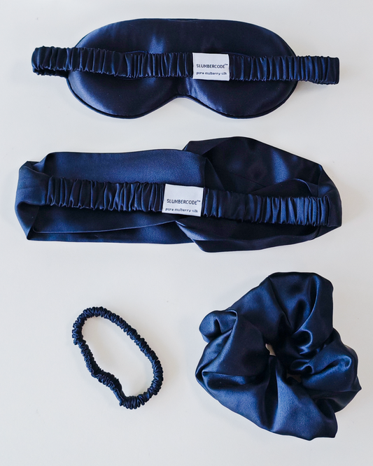 Circadian blue Signature Slumber essential silk set., featuring a 22 momme pure mulberry silk sleep mask, headband, and scrunchies.